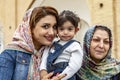 Kashan, Iran - 2019-04-14 - Naqshe Cehan Square three generations pose for the foreign photographer Royalty Free Stock Photo