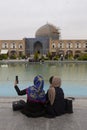 Kashan, Iran - 2019-04-14 - Naqshe Cehan Square two women take a selfie beside pond