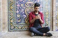 KASHAN, IRAN- SEPTEMBER 23, 2018: A young Iranian man sits near