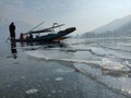 Kashmiri Fisherman Boat on frozen dal lake srinagar Kashmir