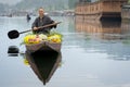 Kashmiri merchants with old wooden boat paddle for selling flowers to tourists in Dal Lake, at Houseboat is the famous place of