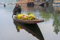 Kashmiri merchants with old wooden boat paddle for selling flowers to tourists in Dal Lake, at Houseboat is the famous place of