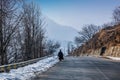 Kashmiri people walking on a snow covered road during the winter season, near srinagar