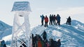 Closeup View of a Snow-covered Bell Tower - Hikers on a snowy mountain peak