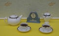 Pale blue Wedgwood watch Jasperware with applied relief plate of white clay next to teacups and saucers, teapot and sugar bowl Royalty Free Stock Photo