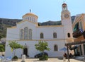 People eating lunch by the Greek Orthodox Church Royalty Free Stock Photo