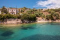 Kastos island summer picturesque nature with turquoise crystal clear water, rocks, green trees, houses - Ionian sea