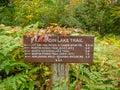 Katahdin Lake Trail sign includes nearby hiking trails and distances in early fall Royalty Free Stock Photo