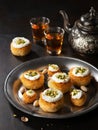 Kataifi, kadayif, kunafa, baklava pastry nest cookies with pistachios with tea. Cooking sweets turkish, or arabic traditional Royalty Free Stock Photo