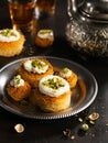 Kataifi, kadayif, kunafa, baklava pastry nest cookies with pistachios with tea. Cooking sweets turkish, or arabic traditional Royalty Free Stock Photo