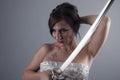 katana, beautiful brunette girl with a Japanese sword in aggressive attitude Royalty Free Stock Photo