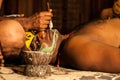 Kathakali exponent preparing for performance by applying face make-up