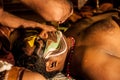 Kathakali exponent preparing for performance by applying face make-up