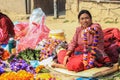 Nepalese woman seller in elegant sari sells flower wreaths at Kathmandu street market