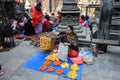 Nepalese woman seller in elegant sari sells flower wreaths at Kathmandu street market