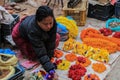 Nepalese woman seller in elegant sari sells flower wreaths at Kathmandu street market