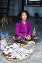 KATHMANDU, NEPAL - APRIL 2015: old woman selling candles in Swayambhunath temple