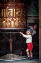 Unidentified Nepalese children near Prayer wheels