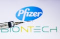 Kathmandu, Nepal - December 02 2020: COVID-19 Vaccine Concept. Syringe full of vaccine dose infront of Pfizer BioNTech Logo. Royalty Free Stock Photo