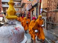 Kathmandu, Nepal - December 17 2019: Young Buddhist monk circulating a Buddhist gompa. Selective Focus - focus on gompa