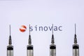 Kathmandu, Nepal - January 03 2021: Closeup of a syringe against Sinovac logo