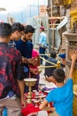 Visitors buying traditional candles for offerings at Monkey temple Swayambhunath Stupa complex, Kathmandu, Nepal.