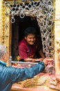 Visitors buying traditional candles for offerings at Monkey temple Swayambhunath Stupa complex, Kathmandu, Nepal.