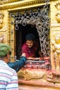 Visitors buying traditional candles for offerings at Monkey temple Swayambhunath Stupa complex, Kathmandu, Nepal.