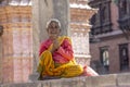 Kathmandu, Nepal, June 20 2019: view of durbar square, a woman in a prayer position with traditional clothes and makeup Royalty Free Stock Photo
