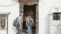 Kathmandu, Nepal - March, 2018: Believers walk around the big paryer wheel in Boudhanath Stupa in the Kathmandu valley.