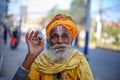 Old Hindu Saint smiling for a photo