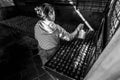 Kathmandu, Nepal - November 22, 2015: Old woman prepares incense butter candles. Boudhanath stupa in Kathmandu, Nepal. Royalty Free Stock Photo