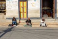 Three men sit on the road at the Swayambhunath temple