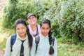 Kathmandu, Nepal - November 04, 2016: Two Nepalese girls in school uniform and a tourist woman smiling to the camera, Kathmandu