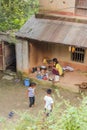 Kathmandu, Nepal - November 04, 2016: Two Nepalese kids playing in front of the house while their mother preparing the meal.