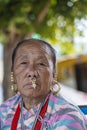 Elderly Nepali woman with traditional nose jewelry on the street market in Kathmandu, Nepal