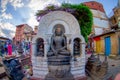 KATHMANDU, NEPAL OCTOBER 15, 2017: Close up of a budha in a stoned sculpture at outdoors in Swayambhunath, is an ancient