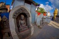 KATHMANDU, NEPAL OCTOBER 15, 2017: Close up of a budha in a stoned sculpture at outdoors in Swayambhunath, is an ancient