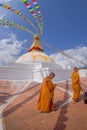 KATHMANDU, NEPAL OCTOBER 15, 2017: Close up of moks praying close the gorgeous monument Boudhanath stupa and its Royalty Free Stock Photo