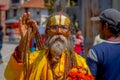 KATHMANDU, NEPAL OCTOBER 15, 2017: Portrait of Nepalese sadhu man holding in his hands a prayer beads on the street of