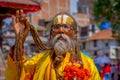 KATHMANDU, NEPAL OCTOBER 15, 2017: Portrait of Nepalese sadhu man holding in his hands a prayer beads on the street of