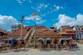 KATHMANDU, NEPAL OCTOBER 15, 2017: Rickshaws parked in empy Durbar square with some tourists near the old Indian temples