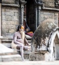 Sadhu sitting on the stairs in Kathmandu city, Nepal