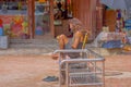 KATHMANDU, NEPAL OCTOBER 15, 2017: Unidentified man, homeless reading a book at outdoors sitting in a public metallic