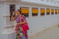 KATHMANDU, NEPAL OCTOBER 15, 2017: Unidentified old woman walking at outdoors near of Boudhanath Stupa building in Royalty Free Stock Photo