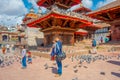 KATHMANDU, NEPAL OCTOBER 15, 2017: Unidentified people standing in the square with a flock of pigeons at Durbar square Royalty Free Stock Photo