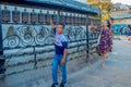 KATHMANDU, NEPAL OCTOBER 15, 2017: Unidentified people walking at outdoors close to Nepalese religious carvings and