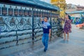 KATHMANDU, NEPAL OCTOBER 15, 2017: Unidentified people walking at outdoors close to Nepalese religious carvings and