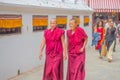 KATHMANDU, NEPAL OCTOBER 15, 2017: Unidentified people walking at outdoors and two monk women walking near of Boudhanath Royalty Free Stock Photo