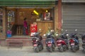 Street fast food restaurant with parked motorcycles and a woman inside